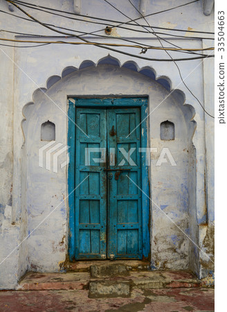 Blue wooden door with the wall of old building Blue wooden door with the wall of old building 33504663