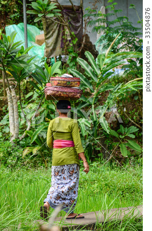 People visit the local temple in Bali, Indonesia 33504876