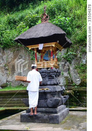 People visit the local temple in Bali, Indonesia 33504878