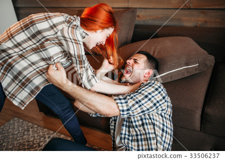 Angry wife beats her husband, domestic violence 33506237