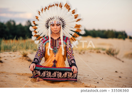 American Indian woman sitting in yoga pose American Indian woman sitting in yoga pose 33506360