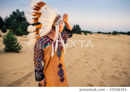 American Indian girl in native costume outdoors American Indian girl in native costume outdoors 33506361
