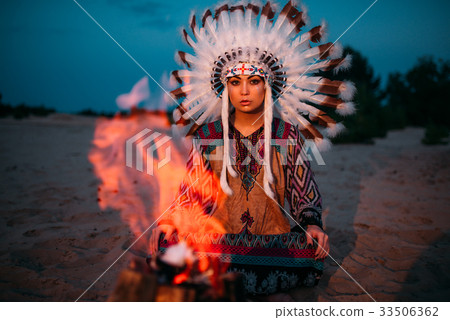 American Indian girl against bonfire, shaman American Indian girl against bonfire, shaman 33506362
