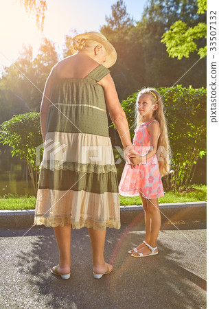 Girl with her granny outdoors. Girl with her granny outdoors. 33507132