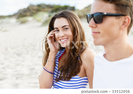 Romantic young couple sitting on the beach Romantic young couple sitting on the beach 33512056
