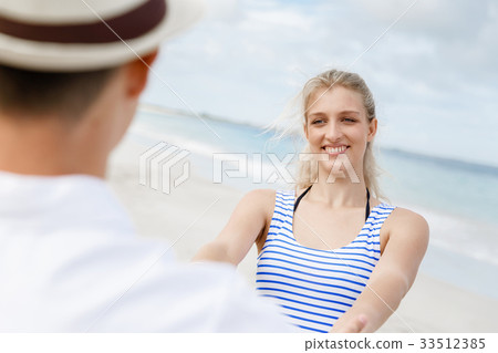 Happy couple having fun on the beach. Happy couple having fun on the beach. 33512385