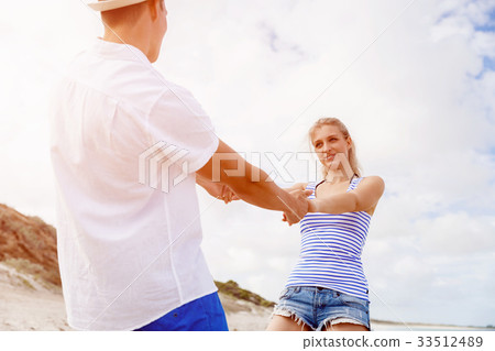 Happy couple having fun on the beach. Happy couple having fun on the beach. 33512489