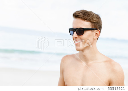 Handsome man posing at beach Handsome man posing at beach 33512621