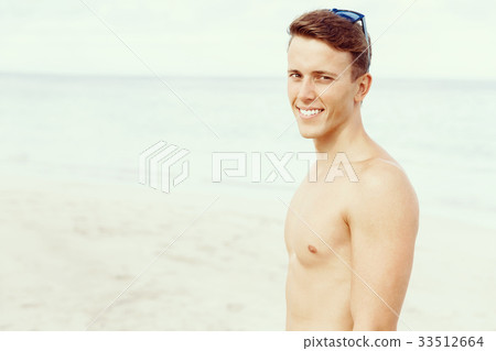 Handsome man posing at beach 33512664