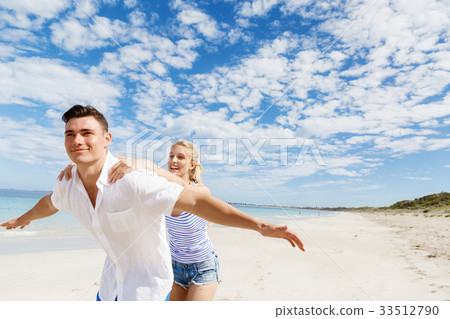 Happy couple jumping on beach vacations Happy couple jumping on beach vacations 33512790