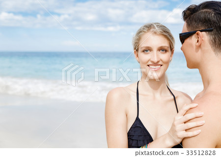 Romantic young couple sitting on the beach Romantic young couple sitting on the beach 33512828