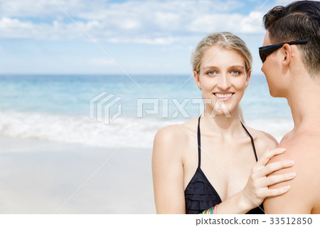 Romantic young couple sitting on the beach Romantic young couple sitting on the beach 33512850