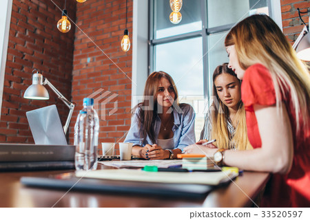 Group of female coworkers working on new project 33520597