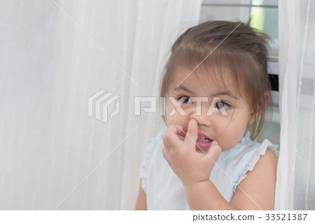 Little Asian girl picking her boogers 33521387