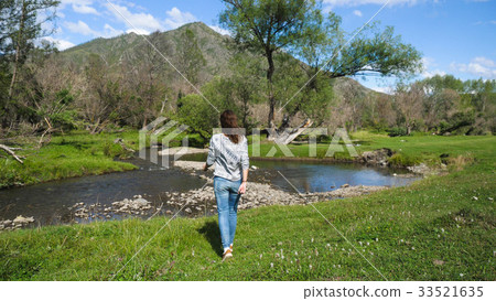 Hiking girl walking alone in beautiful landscape 33521635