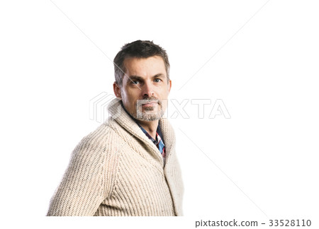 Mature hipster man in beige sweater. Studio shot 33528110
