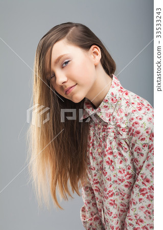 Young cute girl looking at the camera with one eye 33533243