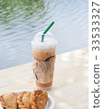 ice coffee with curry on wooden table. 33533327