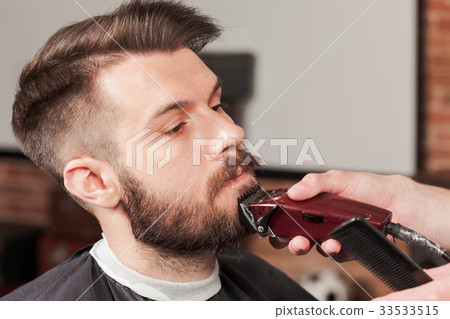 Hipster client visiting barber shop 33533515