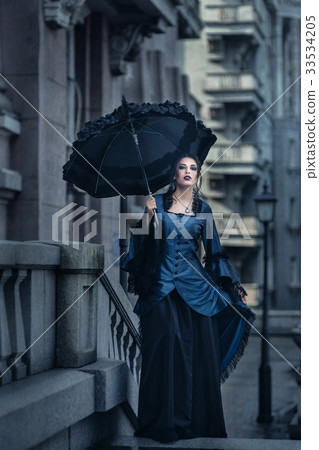 Woman in blue near old building 33534205
