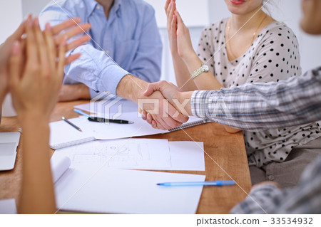 Business people handshaking finishing up meeting 33534932