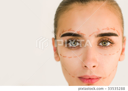 Correction lines on woman face. Close up portrait. 33535288