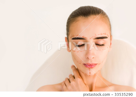 Attractive girl with correction lines on her face. 33535290