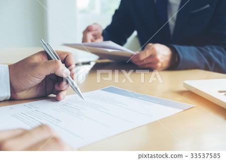 Executive reading a resume during a job interview Executive reading a resume during a job interview 33537585