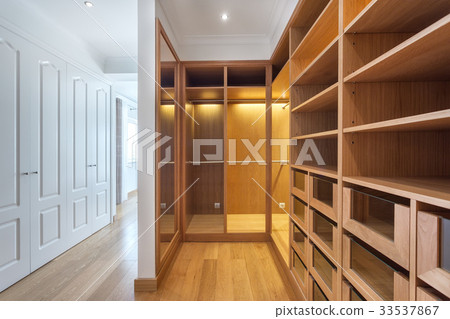 Cabinets and an empty dressing room made of wood Cabinets and an empty dressing room made of wood 33537867