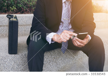 Attractive Confident businessman sitting in a Attractive Confident businessman sitting in a 33538543