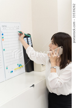 Female employee writing action schedule 33539262