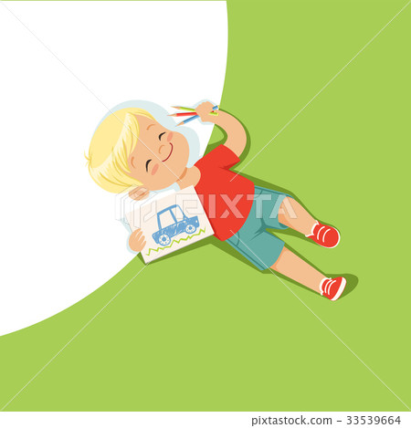Little boy lying on his back and drawing with 33539664