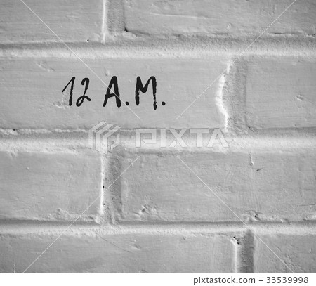 12 A.M. WRITTEN ON WHITE PLAIN BRICK WALL 33539998