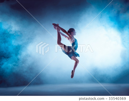 Beautiful young ballet dancer jumping on a lilac 33540369