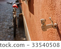 antique decorative window shutter and a blury bike 33540508