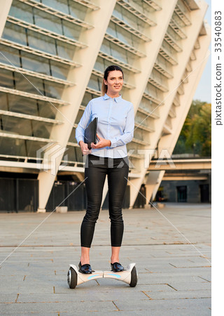 Businesswoman riding hoverboard. Businesswoman riding hoverboard. 33540883