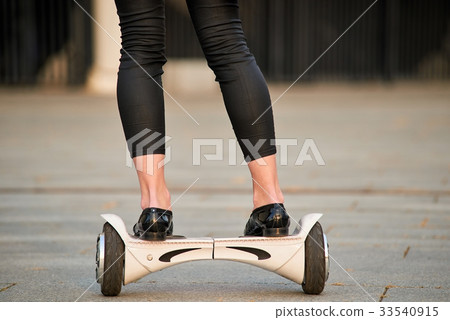 Female legs riding hoverboard. Female legs riding hoverboard. 33540915