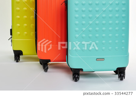 Cropped image of wheeled suitcases. 33544277