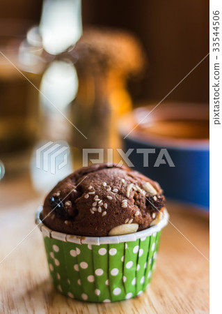 Close up chocolate cupcake on table in cafe shop. Close up chocolate cupcake on table in cafe shop. 33544506