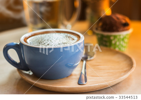 Close up coffee cup with steam on table in cafe. Close up coffee cup with steam on table in cafe. 33544513