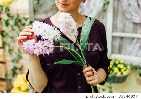 adult woman holding artificial flowers adult woman holding artificial flowers 33544907