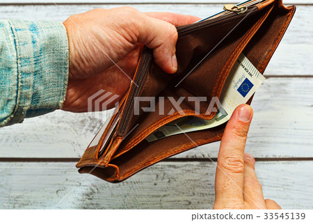 Man holding almost empty leather wallet 33545139