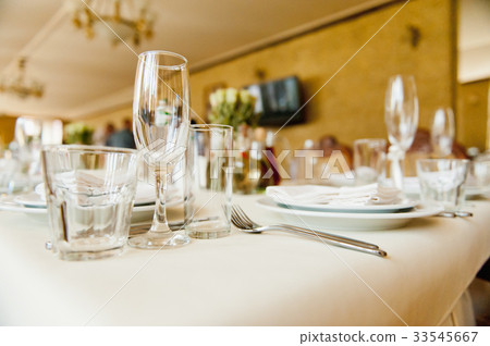 Wedding glasses filled with champagne at banquet Wedding glasses filled with champagne at banquet 33545667