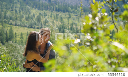 Couple in love cuddling in a nature among the 33546318