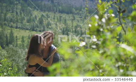 Happy couple in love cuddling in a nature among 33546440
