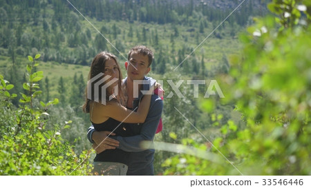 Couple in love cuddling in a nature among the 33546446