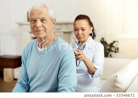 Pleasant elderly man having a medical examination Pleasant elderly man having a medical examination 33546672