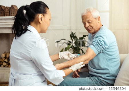 Skillful medical worker doing an injection Skillful medical worker doing an injection 33546804