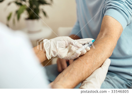 Close up of a syringe needle being inserted into Close up of a syringe needle being inserted into 33546805
