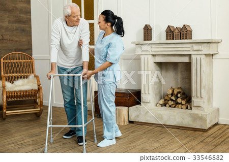 Delighted professional caregiver supporting her Delighted professional caregiver supporting her 33546882